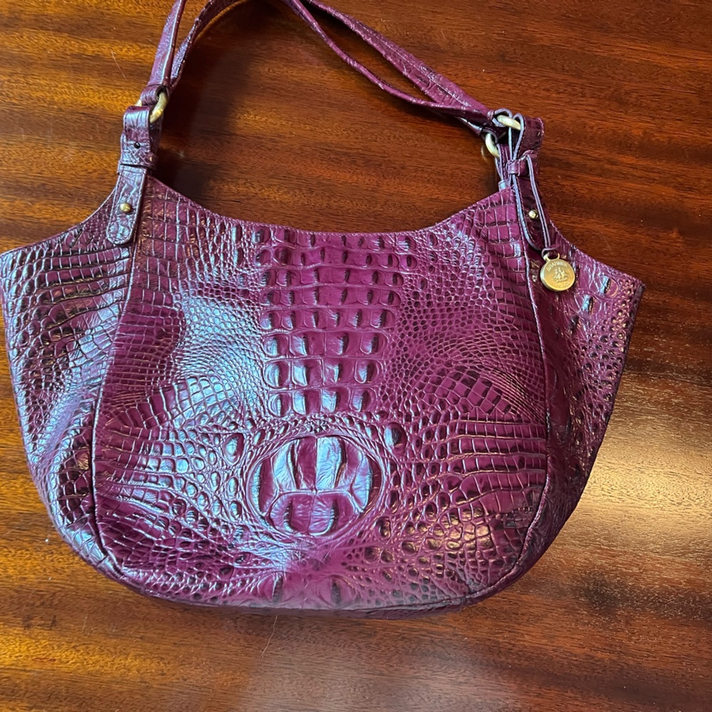 Brahmin croc-embossed leather. Suede interior. Magnetic closure.